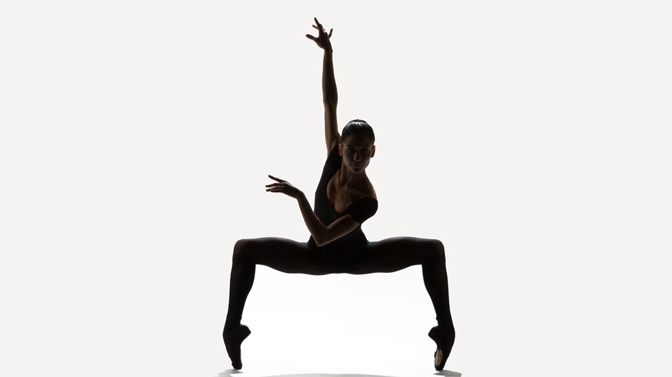 a person dancing in a black leotard